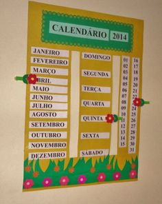 a calendar is hanging on the wall in a room with flowers and green trimmings