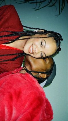 a man and woman with dreadlocks standing next to each other