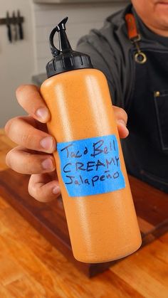 a man is holding a water bottle with the words ice cream sharpener written on it