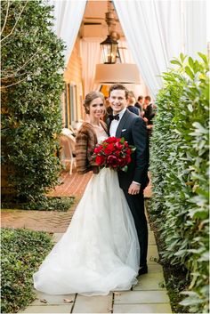 a bride and groom pose for a photo in the garden