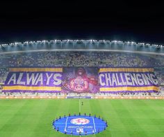 a large banner is on the side of a soccer field