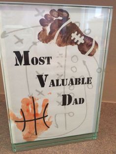 a glass sign that says most valuable dad with an image of a football on it