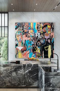 a kitchen with marble counter tops and an abstract painting on the wall