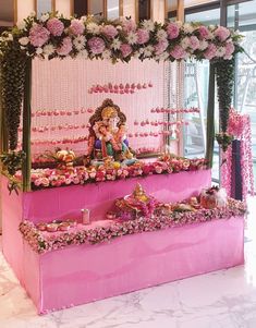 a pink shrine with flowers and decorations