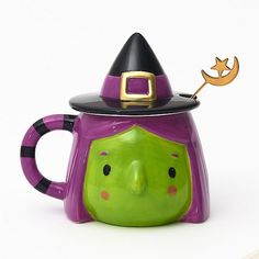 a ceramic mug with a witch's hat on it