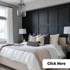 a bedroom with black paneled walls and white bedding