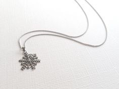 This beautiful snowflake pendant is hand crafted in sterling silver and comes with a 16 inch Rhodium Plated Italian Link Chain. This charming necklace will make the perfect holiday gift and add a meaningful touch to the intended wearer's taste and personality. Material: Sterling Silver Pendant Size: 1 inches long Chain Length: 16 inch Rhodium Plated Italian Cable Chain *Nickel-Free = Hypoallergenic *All purchases will arrive in a gift box! *Available in silver, Rose gold plated and yellow gold p Sterling Silver Jewelry For Winter Gifts, Sterling Silver Necklace For Winter, Winter Sterling Silver Necklace, Silver Jewelry For Winter Gift, Silver Jewelry As Winter Gift, Silver Pendant Necklace For Winter, Holiday Sterling Silver Necklaces, Holiday Sterling Silver Necklaces In Silver, Silver Snowflake Necklace For Gift