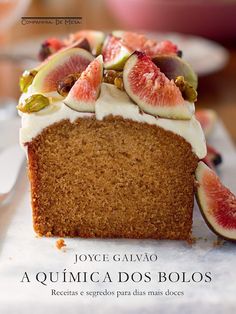 a piece of cake with white frosting and figs on top, sitting on a plate