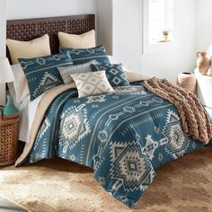 a bed with blue and white comforters in a bedroom