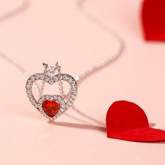 Let love guide your look with this sterling silver heart necklace. Express your love with this "Brilliance Love" double heart pendant love necklace, romantically designed with a small heart in a bigger heart, symbolising two hearts beat as one, representing the bond of love or friendship. The smaller heart is adorned with sparkling heart cut red stone necklace. The stunning stone in the center will help you to say "You are always in my heart". So romantic and lovely. This double heart necklace m Valentine's Day Double Heart Cubic Zirconia Necklace, Valentine's Day Cubic Zirconia Heart Necklace, White Gold Necklaces For Valentine's Day, Valentine's Day White Gold Necklace, Valentine's Day Heart Cut Diamond Necklace, Fine Jewelry Double Heart Necklace For Valentine's Day, Valentine's Day Cubic Zirconia Heart Necklace With Clavicle Chain, Valentine's Day Heart Necklace With Cubic Zirconia Clavicle Chain, White Gold Double Heart Necklace For Valentine's Day