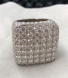 a silver ring with lots of diamonds on it