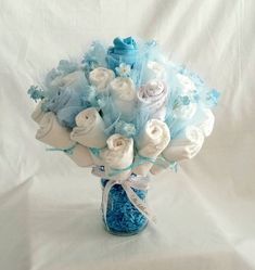 a blue vase filled with white and blue flowers