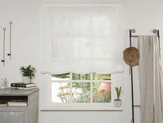 a bathroom with a sink, toilet and window