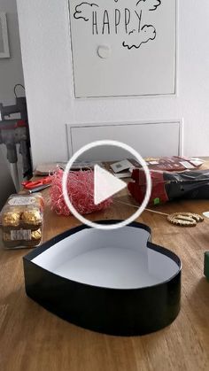 a black and white box sitting on top of a wooden table