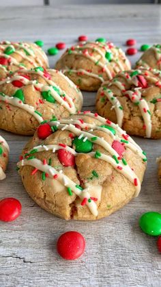 cookies with white icing and sprinkles on a table