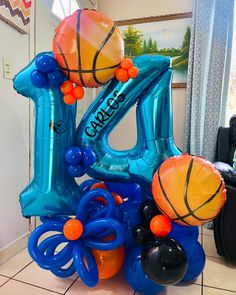 an inflatable number one balloon with basketballs and balloons attached to it on the floor