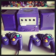 two purple video game controllers sitting next to each other