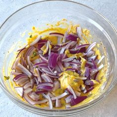 onions and cheese in a glass bowl on a white counter top, ready to be cooked