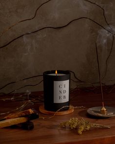 Like a crackling fire in a cozy cabin, smoky notes of woodsmoke, incense, and cedar embers meld together to form a blanket of aroma, enveloping you in its warmth. Dark Candle Aesthetic, Candle Product Photography, Masculine Candle, Candle Photoshoot, Candle Board, Monochrome Aesthetic, Hinoki Cypress, Brooklyn Candle Studio, Candles Dark