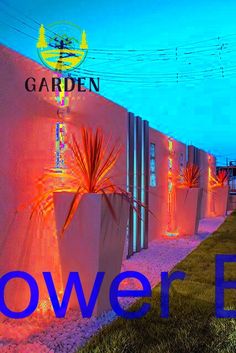 an outdoor garden with plants and lights on the side of a building that says power