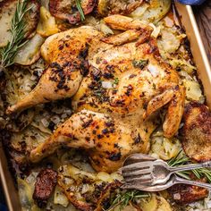 a roasting pan with chicken, potatoes and rosemary garnishes on it