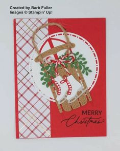 a handmade christmas card with an ornament hanging from it's side