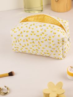 "The Floral Quilted Makeup Bag is the perfect way to keep all of your makeup essentials organized and within reach. Made with quilted fabric and featuring yellow flowers, this makeup bag is cute and stylish. It's available in three different sizes to fit all of your needs: mini, regular, and large. The Floral Quilted Makeup Bag makes the perfect gift for any makeup lover, and is sure to please for any occasion.🌸 🧺Materials: Cotton fabric is used in the outer and inner fabric. There is a fiber Yellow Cosmetic Bag With Removable Pouch For Everyday Use, Yellow Zipper Pouch Cosmetic Bag For Everyday Use, Yellow Pouch Cosmetic Bag For Everyday Use, Yellow Everyday Pouch Cosmetic Bag, Yellow Rectangular Cosmetic Bag With Removable Pouch, Yellow Cosmetic Pouch For Everyday Use, Yellow Pouch Cosmetic Bag For Daily Use, Yellow Zipper Pouch Cosmetic Bag, Floofy Fluff