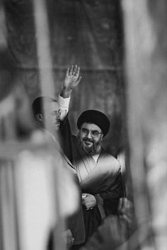 a black and white photo of a man waving