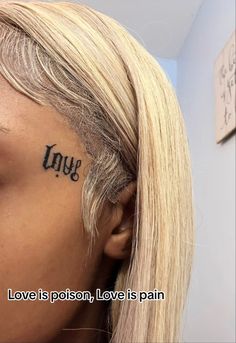 a woman's face with the word love written on her forehead and behind her ear