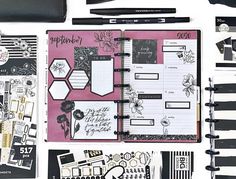 the contents of a planner spread out on a white surface with black and pink accents