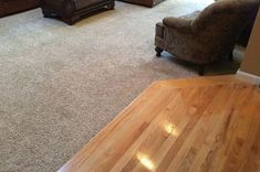 a living room filled with furniture and hard wood flooring