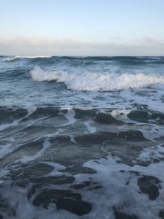 the ocean waves are rolling in to shore