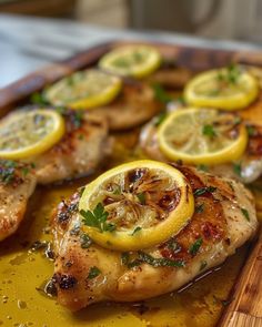 chicken with lemons and herbs on a cutting board