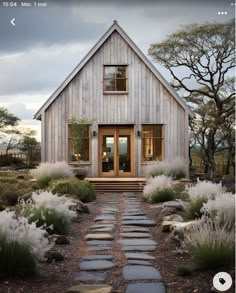 a house with stone pathway leading to the front door