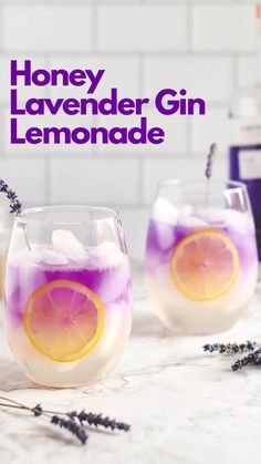 two glasses filled with lemonade sitting on top of a counter next to lavender flowers