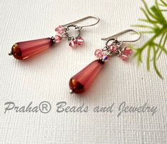 Czech glass faceted dangle drop earrings look vintage with pink semi-translucent glass beads trimmed in gold. Swarovski crystals are clustered atop sterling silver end caps. Glass beads measure 20 MM. All sterling silver components, including handcrafted ear wire. The earrings measure 2" from the top of the handcrafted ear wire. These earrings are quite light weight. Glass Crystal Earrings, Czech Glass Earrings, Creative Earrings, Czech Glass Jewelry, Bead Projects, Translucent Glass, Jewelry Boutique, Red Jewelry, Bead Store