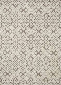 a white and brown rug with an intricate design on it's side, in the middle