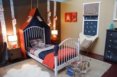 a child's bedroom with a tent bed, dresser and night stand in the corner