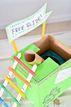 a green box with toothbrushes and clothes pins in it that says free slide