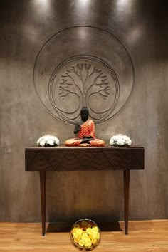 a buddha statue sitting on top of a wooden table