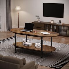 a living room with a laptop on the coffee table