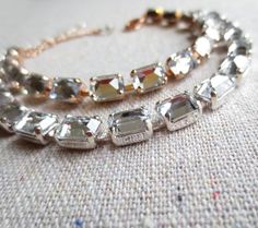 "Heatherly Designs tennis bracelet made using vintage genuine Swarovski® crystals in clear faux diamond that have been set upside down in plated brass. Bracelet closes with a lobster clasp and comes with a chain extender. ●Nickel free ●Length (adjustable): 6.25\" - 7.75\" or 18.88 - 19.69cm ●Swarovski® crystal color name(s): Crystal ●Arrives in our signature Heatherly gift box. Handmade with ❤ by Heather ● ● ● ● ● ● ● ● ● ● ● ● ● ● ● ● ● ● ● ● ● ● ● ● ● ● ● ● →Quantity Discounts listed below: 10 Gold Tennis Bracelet, Diamond Baguette, Bracelet Wedding, Jewelry Bridesmaid, Box Handmade, Etsy Bridesmaid Gifts, Brass Bracelet, Wedding Bridal Jewellery, Crystal Rose