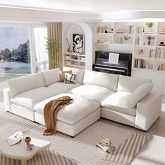 a living room filled with white furniture next to a large window covered in bookshelves