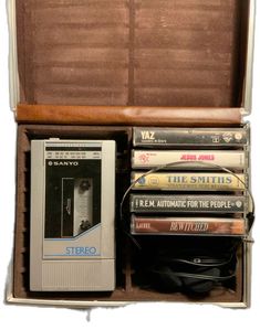 an open briefcase filled with lots of different types of books and video games on top of each other