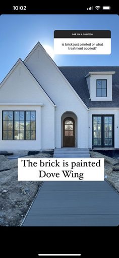 the brick is painted dove wing in front of a house with an ad on it