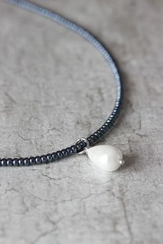 This delicate minimalist necklace was made of black hematite seed beads, white crystal pearl coated drop bead, strong nylon double thread with silver tone clasps, stainless steel adjustable length chain and silver tone lobster clasp. Perfect jewelry for everyday wear! The length of necklace is 40 cm (or about 15.8 inches) and 5 cm of adjustable length chain. Other necklaces you can find in my store in the necklace section. https://www.etsy.com/shop/NaTavelli?section_id=14843046&ref=shopsecti Silver Teardrop Jewelry With Tiny Beads, Minimalist Beaded Necklace With Pearl Drop, Minimalist Single Strand Beaded Necklace, Minimalist Drop Pearl Necklace, Minimalist Adjustable Pearl Chain Drop Necklace, Handmade Minimalist Pearl Choker Necklace, Minimalist Pearl Pendant Jewelry With Round Beads, Minimalist Handmade Pearl Choker Necklace, Minimalist Pearl Drop Necklace With Round Beads