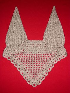 a crocheted bib on a red background