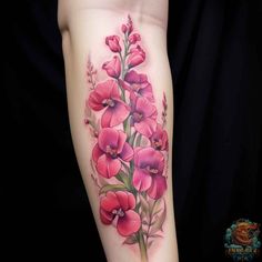 a woman's arm with pink flowers and leaves on the left side of her body