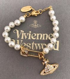 Vivienne Westwood Gold Pearl Safety Pin Saturn Bracelet 6 / 6.5 / 7 Inches due to included tail adjustment, comes with free pouch. Vivienne Westwood Pearl Bracelet, Vivienne Westwood Safety Pin, Gold Vivienne Westwood, Saturn Bracelet, Vivienne Westwood Bag, Vivienne Westwood Bracelet, Vivienne Westwood Fashion, Vivienne Westwood Jewelry, Vivienne Westwood Bags