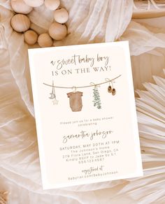 a baby is on the way card next to shells and seashells, along with an ornament that reads sweet baby boy is on the way